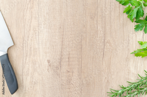 Herbs with knife on wood table