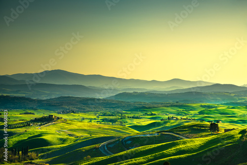 Volterra panorama  rolling hills  trees and green fields at sunset. Tuscany  Italy