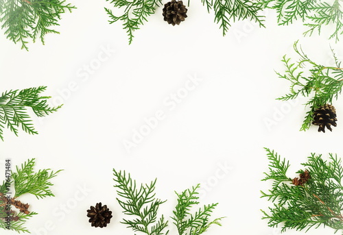 Christmas frame of pine branches and pine cones on white background. Christmas, winter, new year concept. Flat lay, top view, copy space