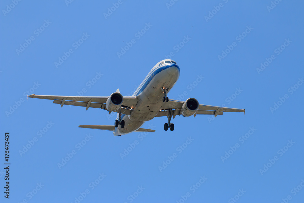 Passenger Airplane Taking Off Into The Blue Sky