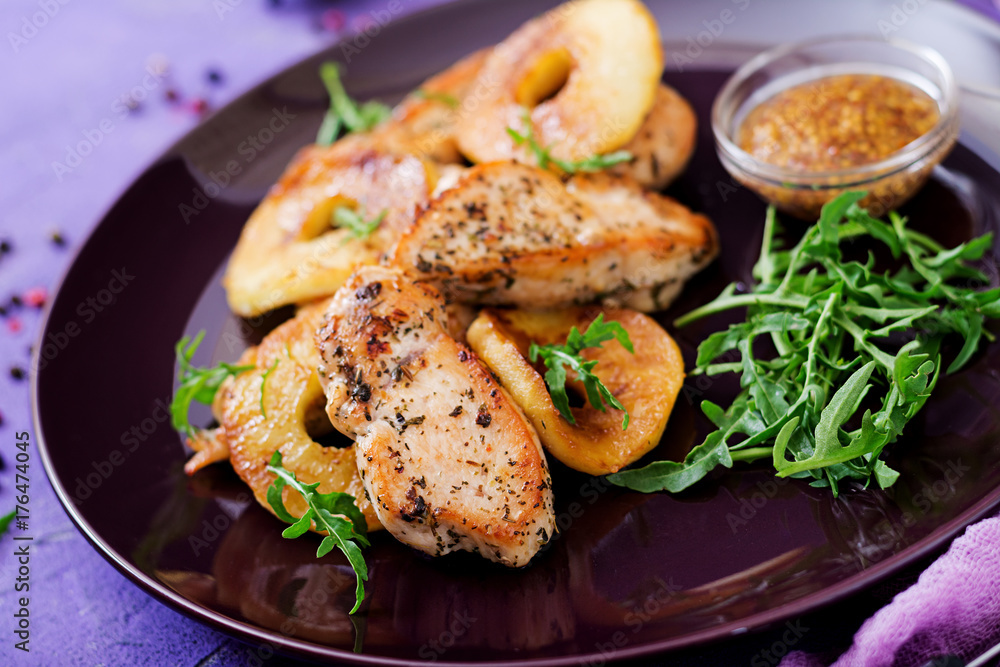 Chicken fillet with apples cooked on grill.
