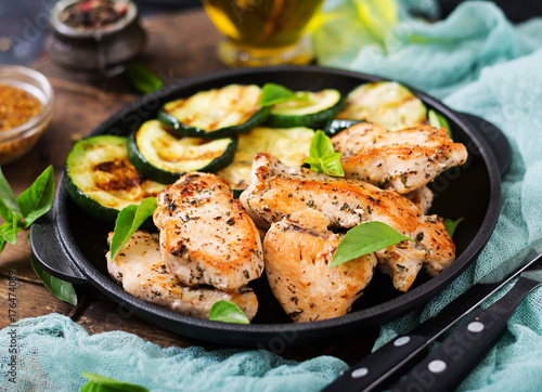 Chicken fillet with zucchini cooked on grill.