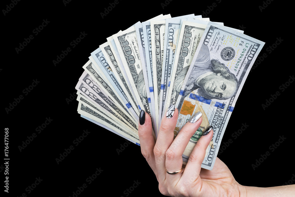 Hand with money isolated on black background. US Dollars in hand. Handful  of money. Business woman offering money. Counting money. Hand holds a  bundle of dollar bills. Financial Credit concept. Stock Photo |