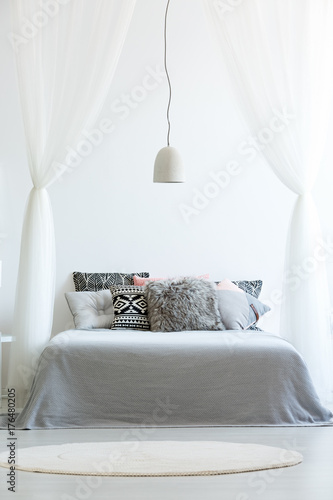 Patterned pillows on canopy bed