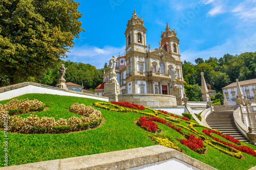 Tenoes near Braga. Sanctuary of Bom Jesus do Monte in neoclassical style and prospective view of bloom gardens in a sunny day, blue sky. Popular landmark and pilgrimage site in northern Portugal. photo