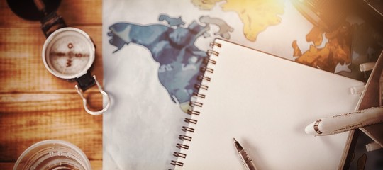Overhead view of diary with map and camera