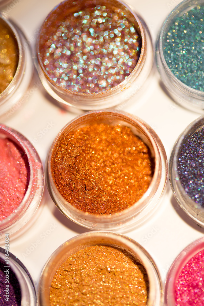 Cosmetics. Pigments for make-up, eyes, lips, face and body. Brilliant radiant, scattered multicolored powders. Cosmetics. Pigments for make-up, eyes, lips, face and body. Brilliant radiant, scattered multicolored powders.