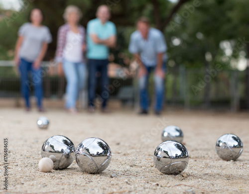 Males and females playing petanque photo