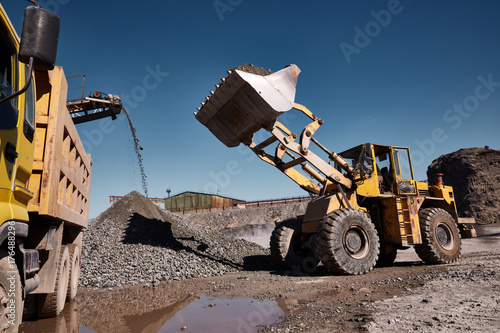 Front loading excavator loading the truck photo