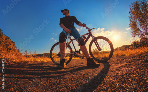  caucasian athletic guy in a knee pads relies on a sports bike