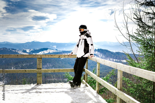 Fototapeta skier standing on the observation deck with