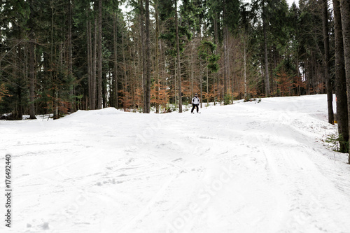 skier is skiing down the slope in the woods © producer