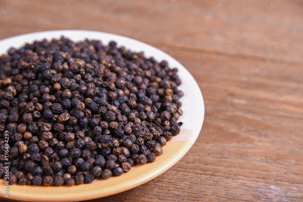 black pepper on old wooden table black pepper on old wooden table