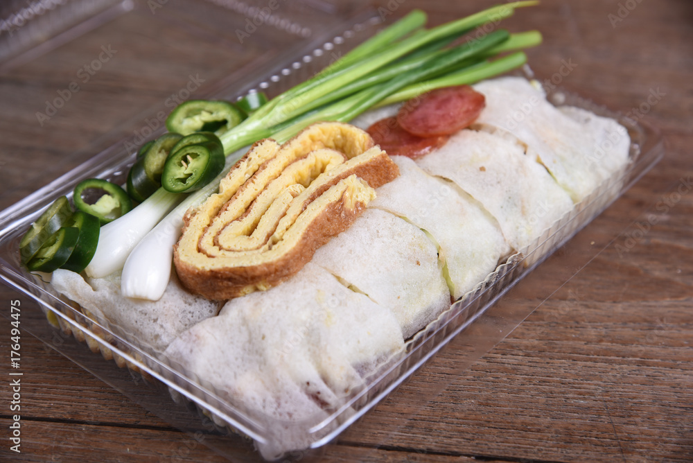 Fresh spring rolls , egg ,sausage wrap with flour topped with sauce and crab meat. Fresh spring rolls , egg ,sausage wrap with flour topped with sauce and crab meat.