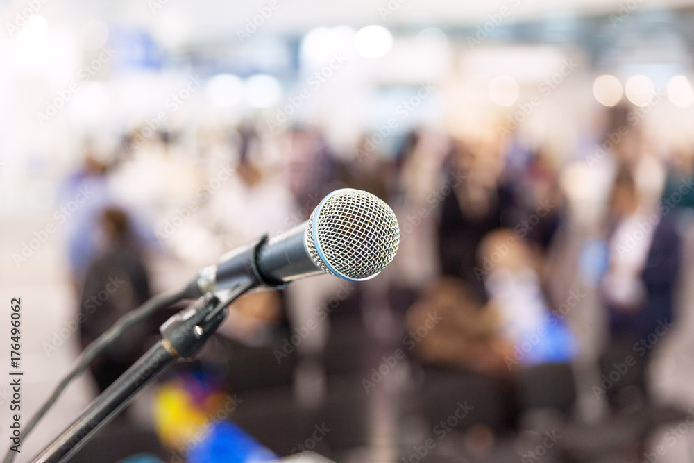 Microphone in focus against blurred audience. News conference. Microphone in focus against blurred audience. News conference.