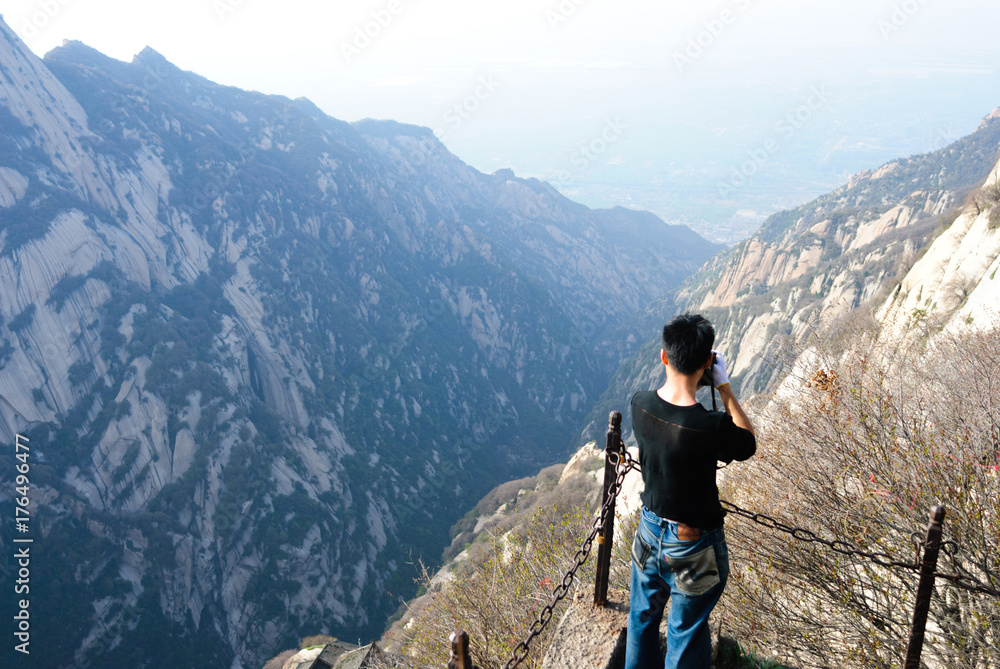 Man standing in front of Huashan mountain view in China Man standing in front of Huashan mountain view in China