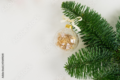 White christmas - decoration ball and fir tree twig, copy space on white background