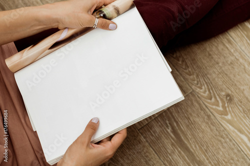 Young woman with a booklet with blank pages