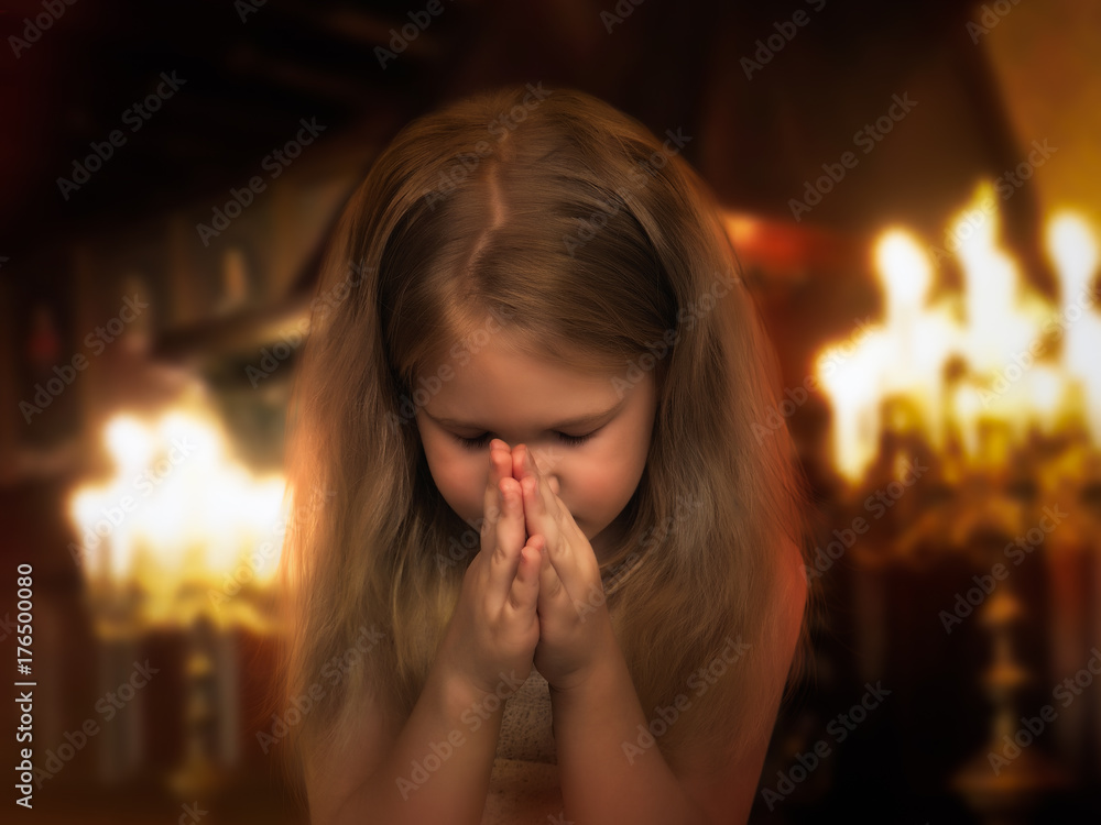 Beautiful little girl folded her hands in a prayerful gesture. Child ...