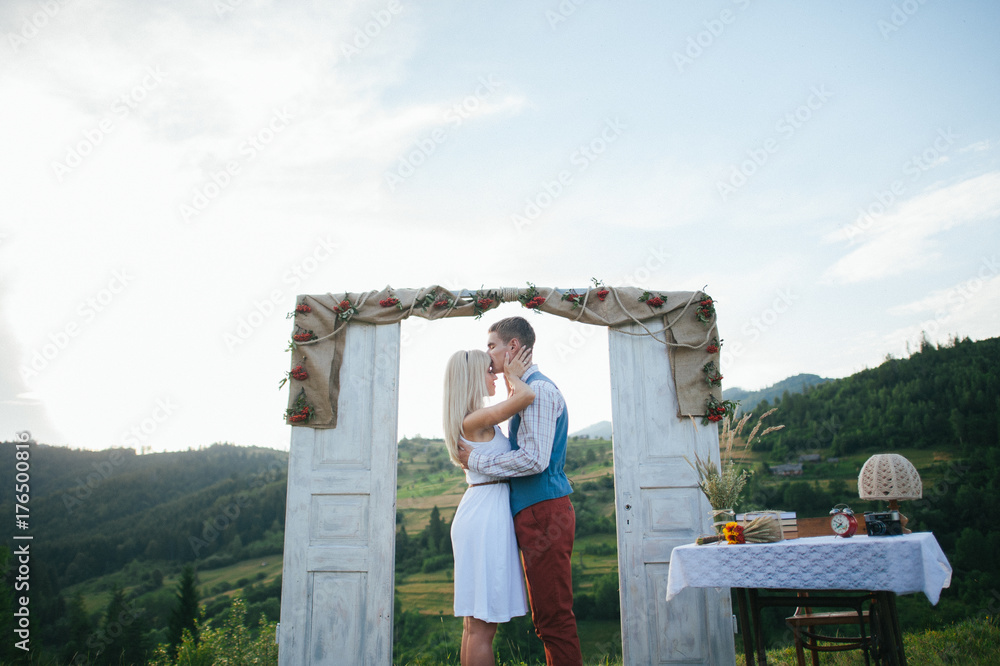happy couple near wedding frame