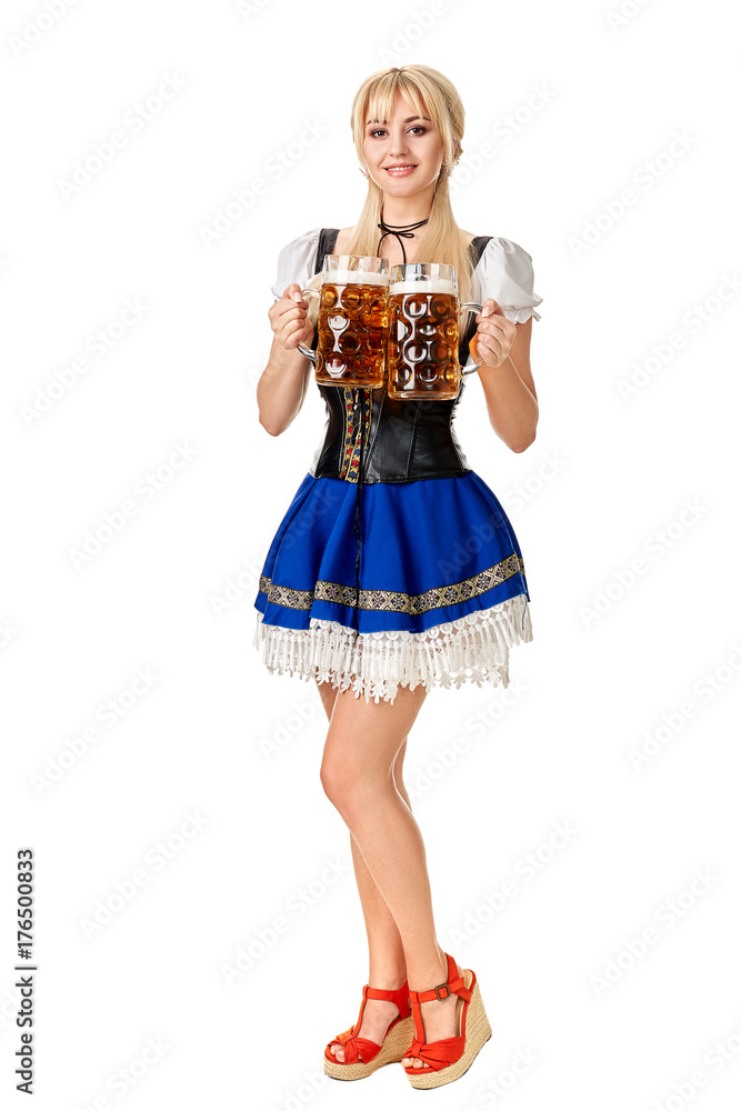 Full length portrait of a blond woman with traditional costume holding beer glasses isolated on white background. Full length portrait of a blond woman with traditional costume holding beer glasses isolated on white background.