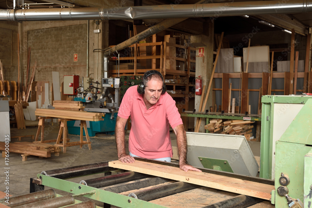 carpenter polishing wood in a carpentry workshop carpenter polishing wood in a carpentry workshop