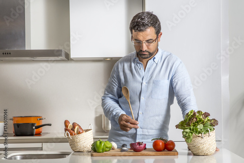 arab man preparing food in his urban apartment