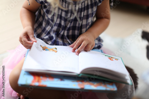 girl reading, child studying children's book photo