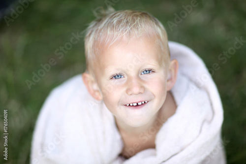 wellness and beauty, personal hygiene, scandinavian summertime, cute danish boy wet with towel smiling