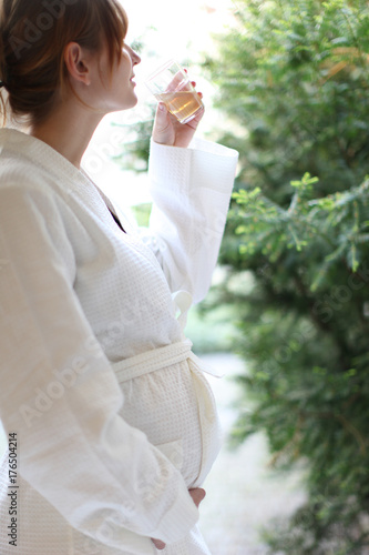 happy pregnant woman drinking tea, morning scene, relaxed and excited, health club and green yard