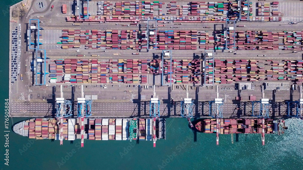 Commercial port with container ships - Top down aerial view.