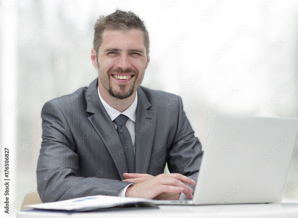 closeup.smiling businessman working with laptop closeup.smiling businessman working with laptop