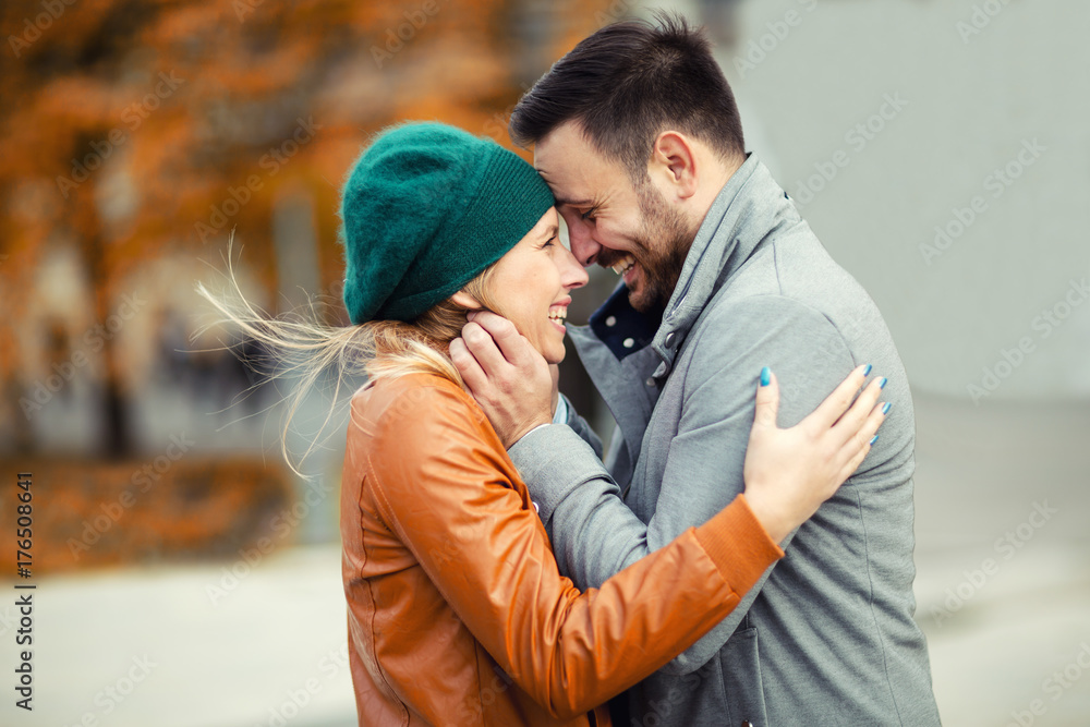 Smiling couple in love outdoors.Young happy couple hugging on the city street. Smiling couple in love outdoors.Young happy couple hugging on the city street.