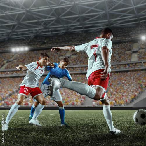 Soccer players performs an action play on a professional stadium. Two football teams fighting for the ball. Players wears unbranded sport uniform. © Alex