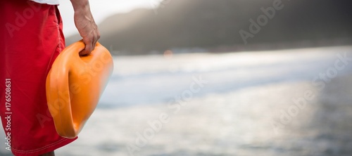 Foto Composite image of cropped image of man holding rescue buoy