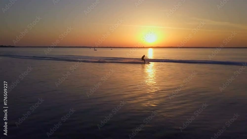 Water skiing man rides in beautiful sunset ocean drone footage Water skiing man rides in beautiful sunset ocean drone footage