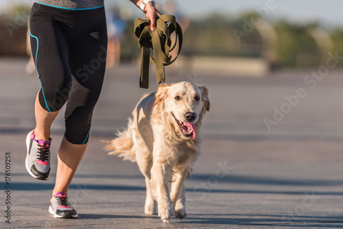 sportswoman jogging with dog