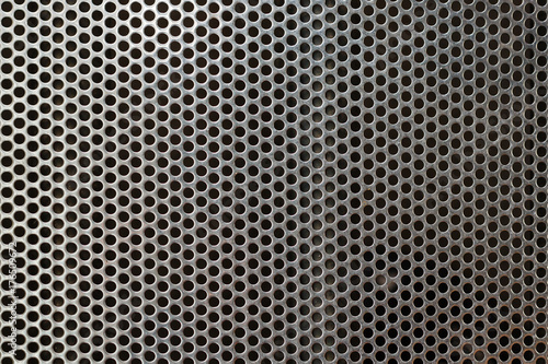 Metal mesh texture background over brushed metal sheet