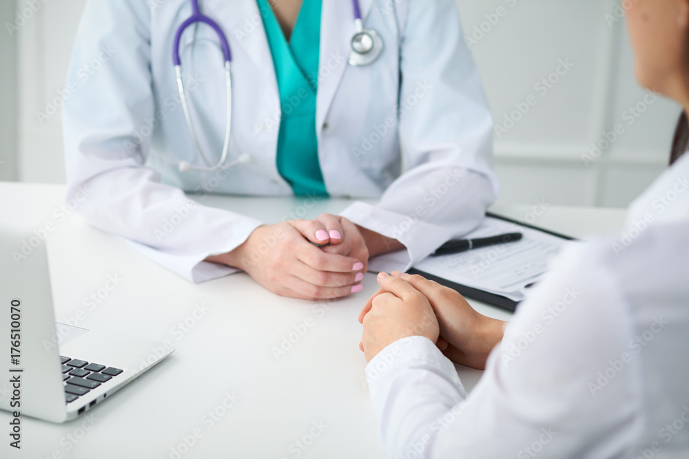 Doctor and patient, close-up of hands. Physician talking about medical examination results. Medicine, healthcare and helping concept Doctor and patient, close-up of hands. Physician talking about medical examination results. Medicine, healthcare and helping concept