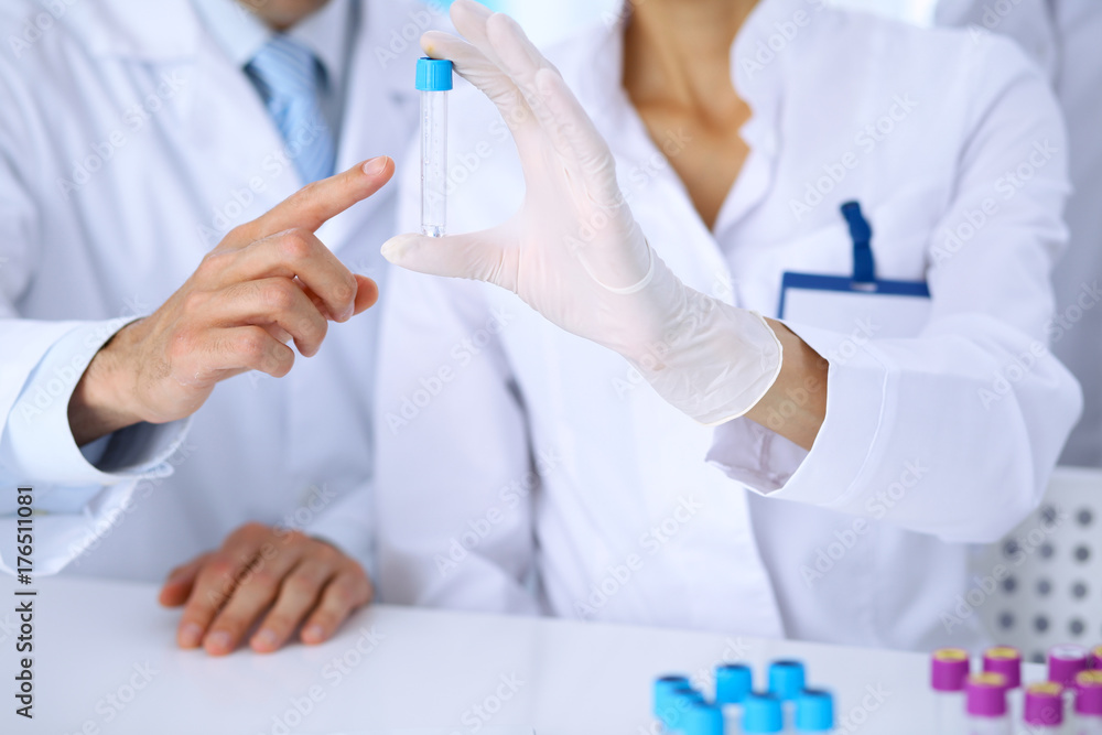 Team of scientific researchers in laboratory studying substances or blood sample. New vaccine for pharmacology industry is s almost ready. Medicine and science concept Team of scientific researchers in laboratory studying substances or blood sample. New vaccine for pharmacology industry is s almost ready. Medicine and science concept