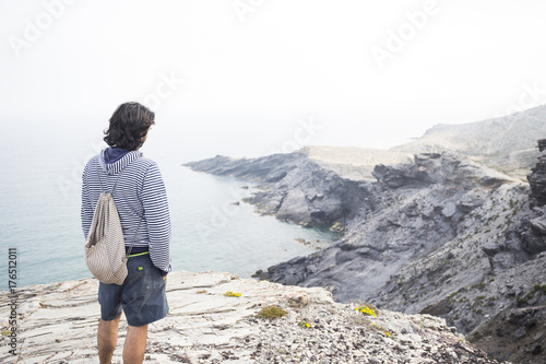 Spain, Murcia, young man looking at the sea photo