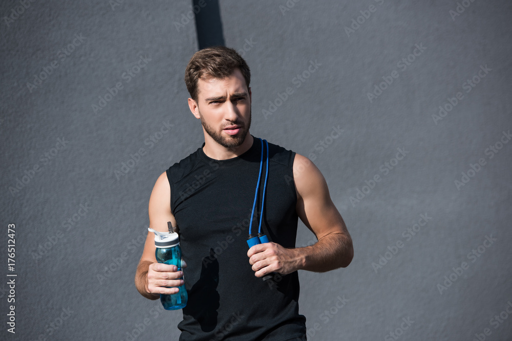 sportsman with skipping rope and water bottle sportsman with skipping rope and water bottle