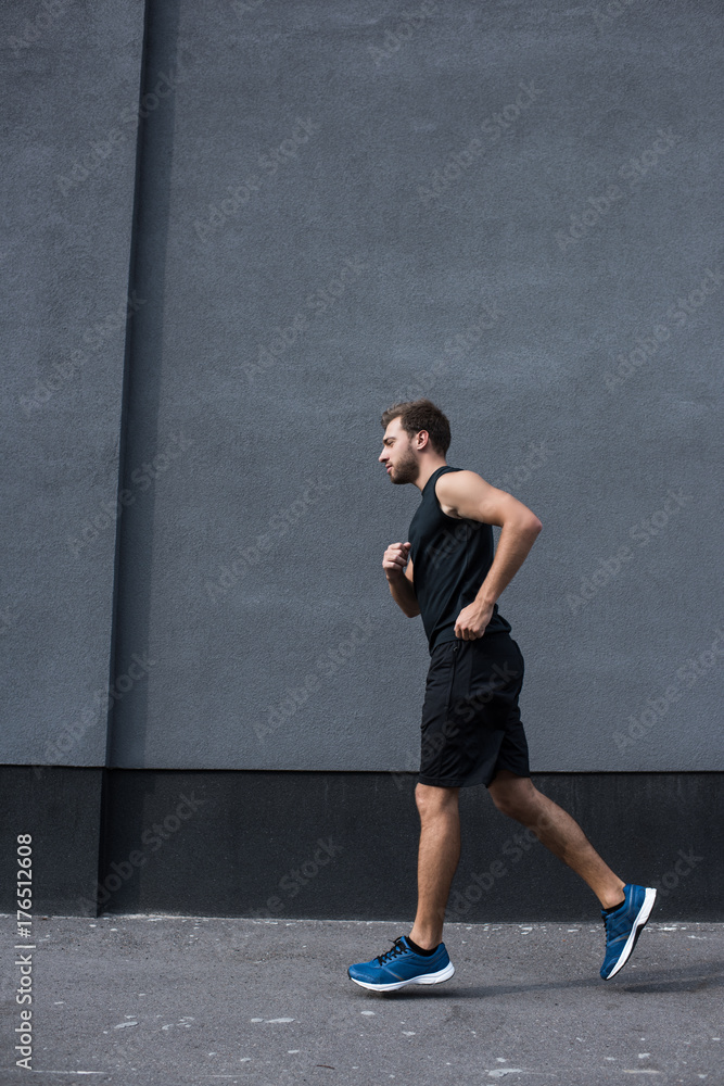 athletic sportsman jogging outside