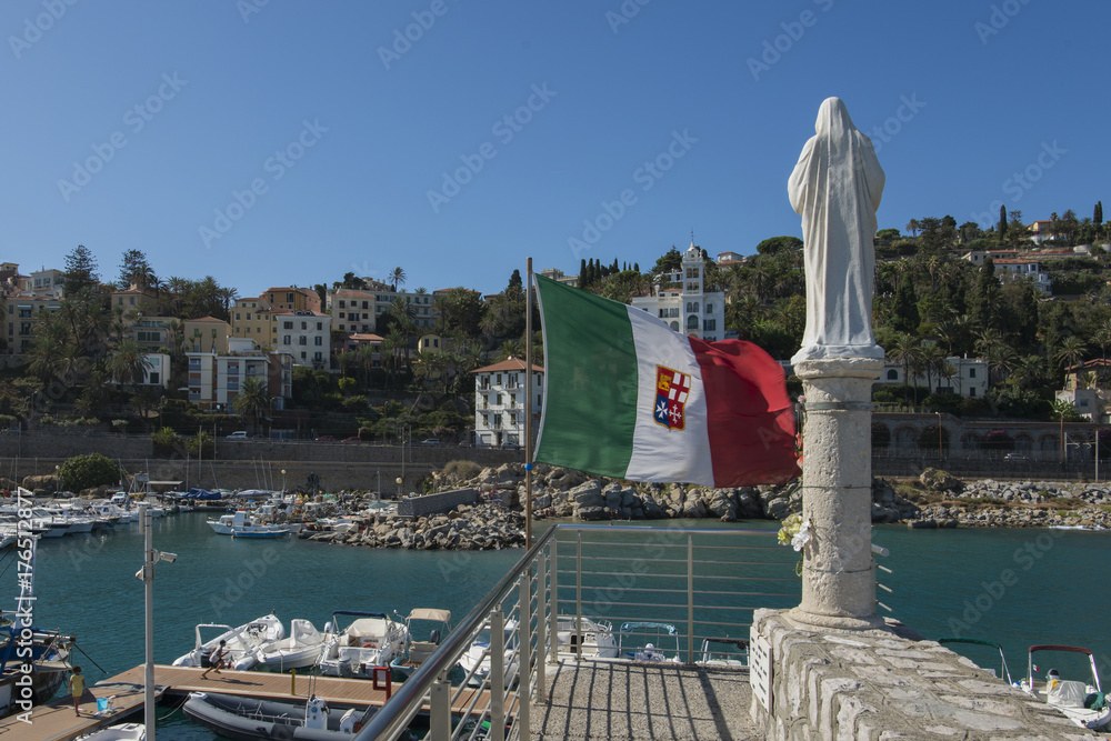Italy,Liguria,Bordighera, the tourist port, with a statue at entrance.