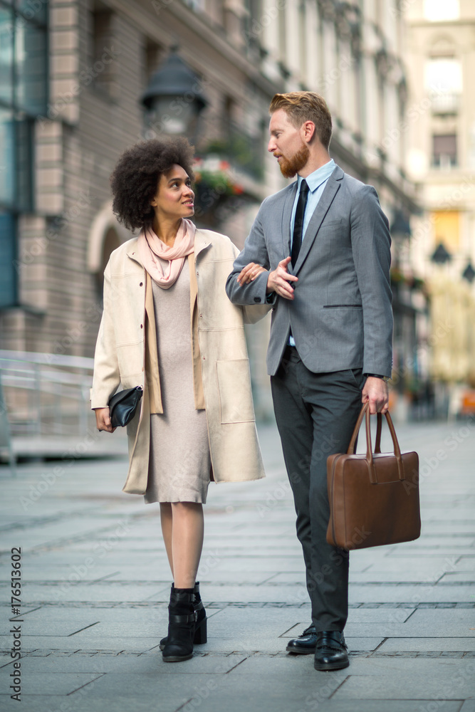 Fototapeta premium Happy business couple using smart phone outdoors