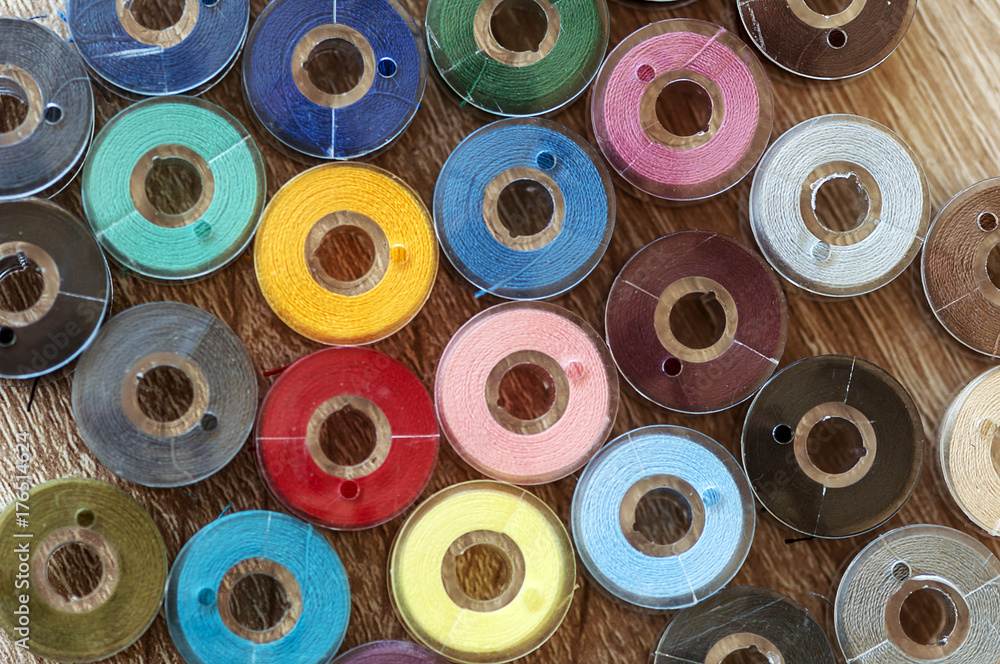 Fototapeta premium Close-up on colored sewing threads on spools