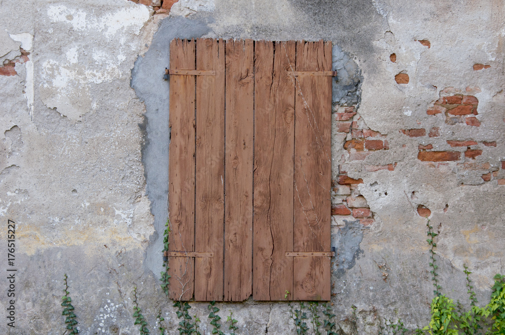old window with closed wooden shutters old window with closed wooden shutters