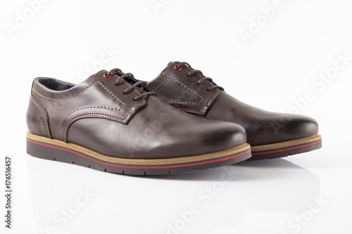 Male brown leather shoe on white background, isolated product, comfortable footwear. © GeorgeVieiraSilva