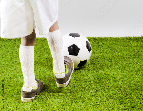 The soccer player's foot touches the soccer ball.