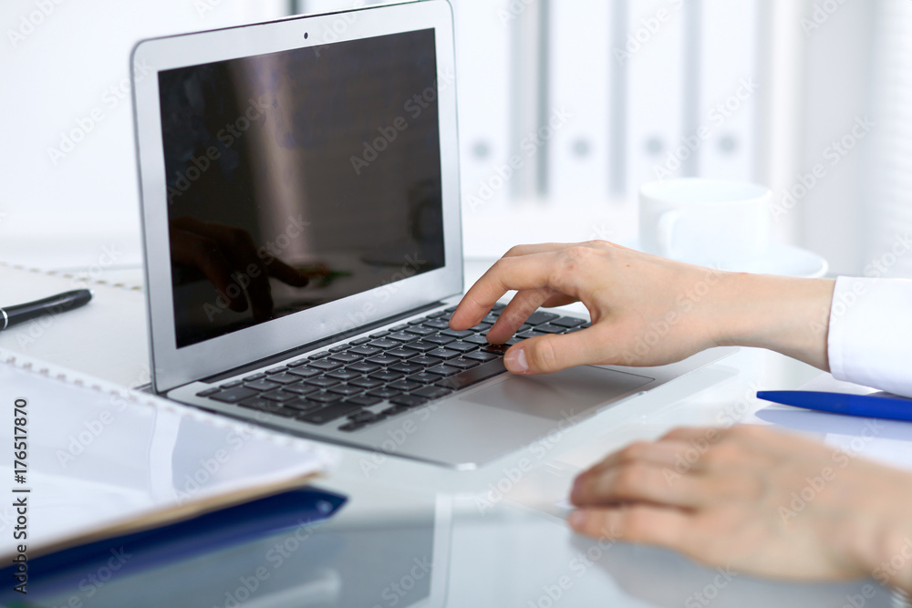 Close up of business woman hands typing on laptop computer Close up of business woman hands typing on laptop computer